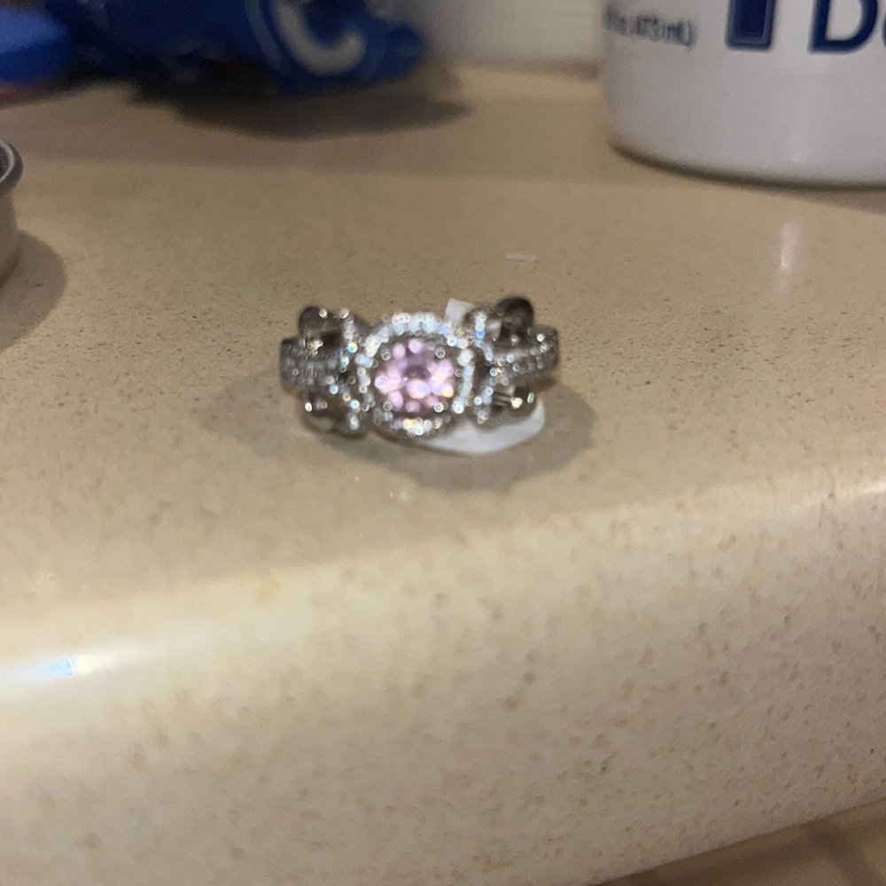 New ring size 7. Pink interior stone and cz accents pretty antique looking ring